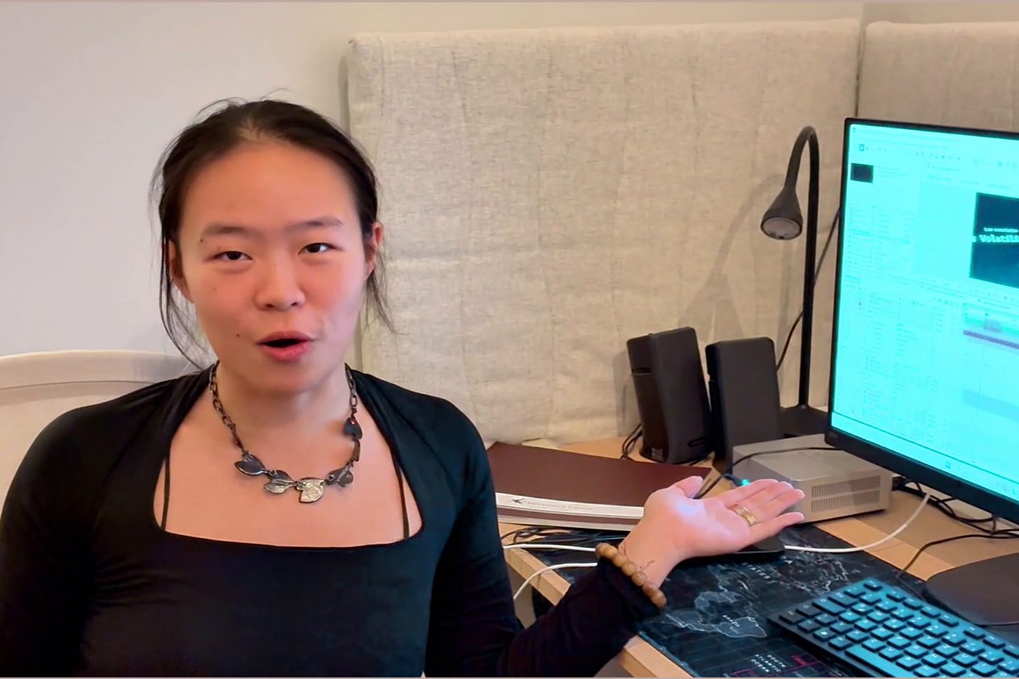 An intern at her desk describing a video edit on screen